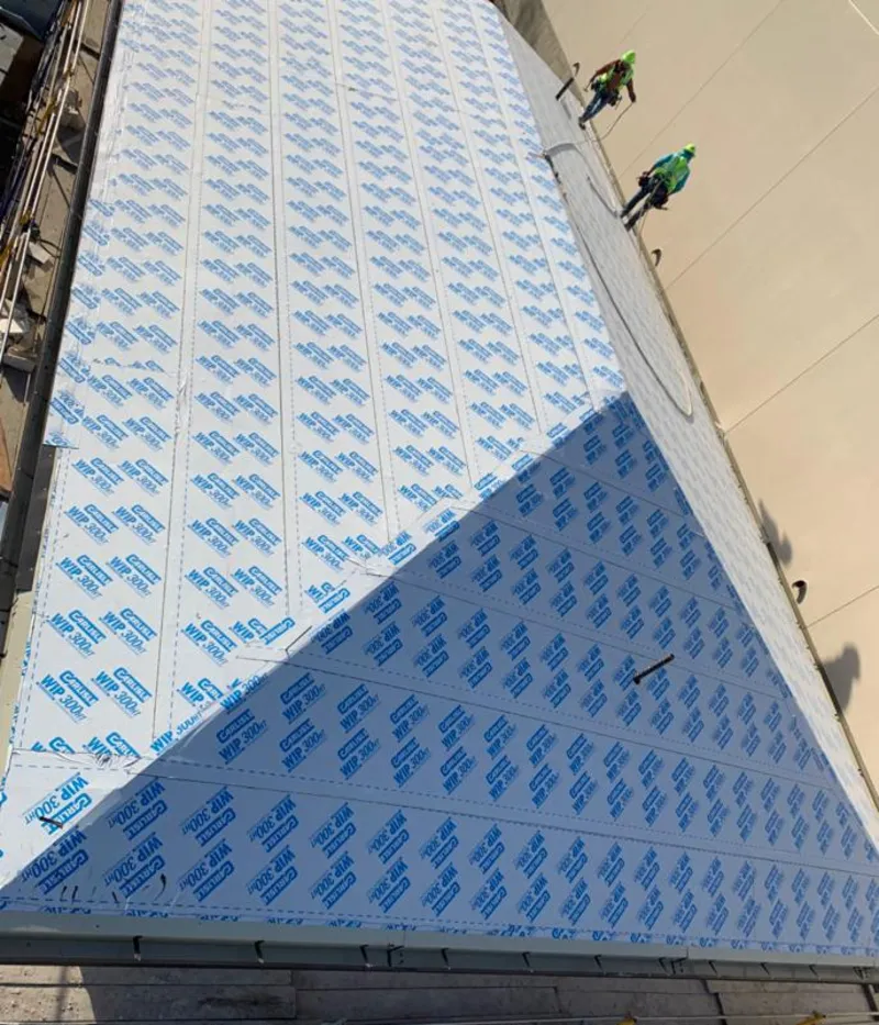 Professional roofers installing underlayment on a metal roof in Vernon Hills